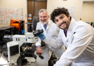 Dr. Keir Fogarty, associate professor of chemistry, works with Jake Ankrum in the laboratory.
